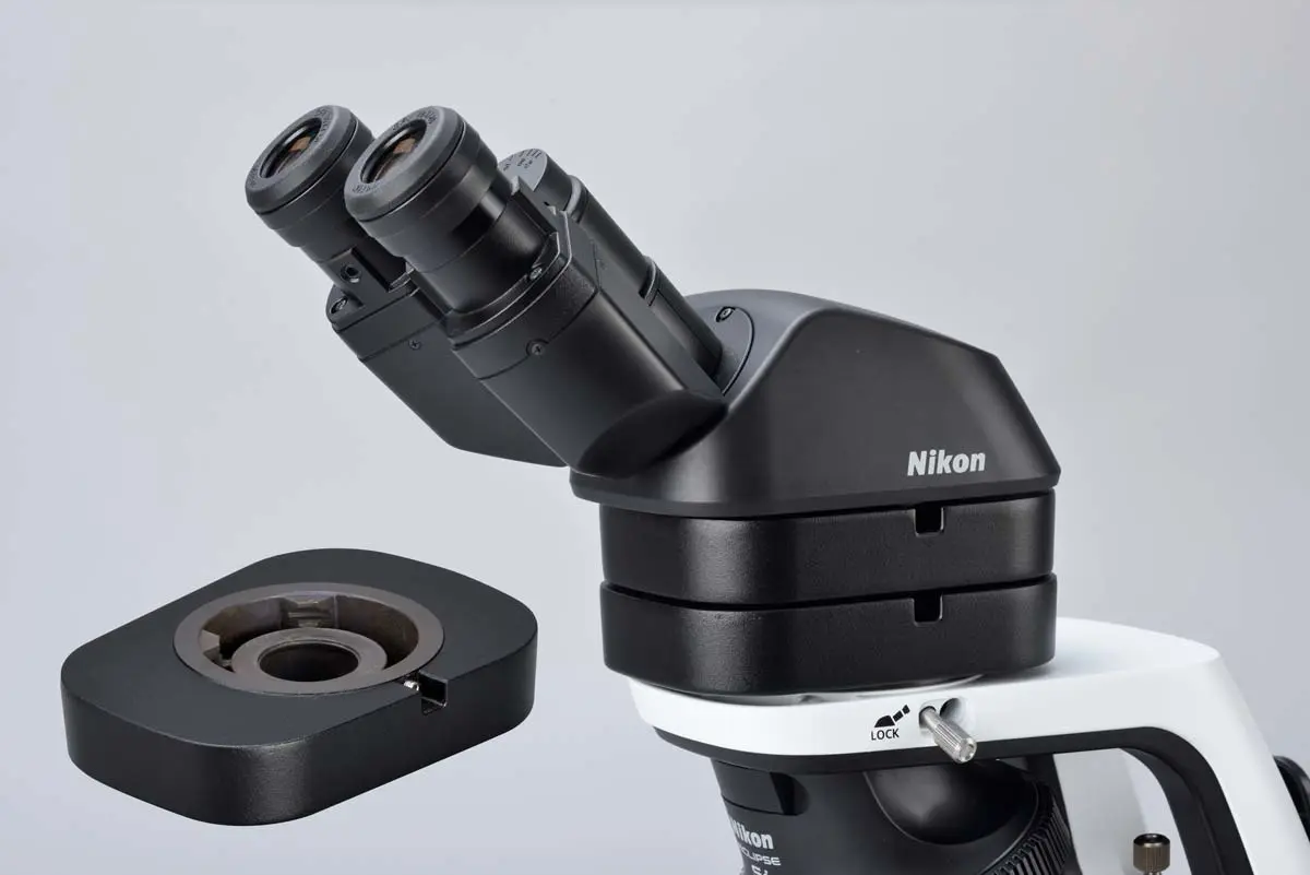 Optional eye-level riser accessory mounted beneath the eyepiece tube to raise eyepoint height